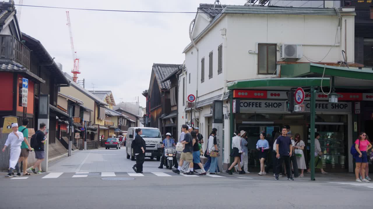 Slow motion shot of Crowds of Tourists in Kyoto at Gions Hanamikoji Street