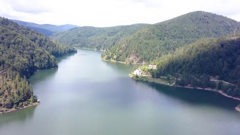 spinning aerial shot over the top of a mountain lake