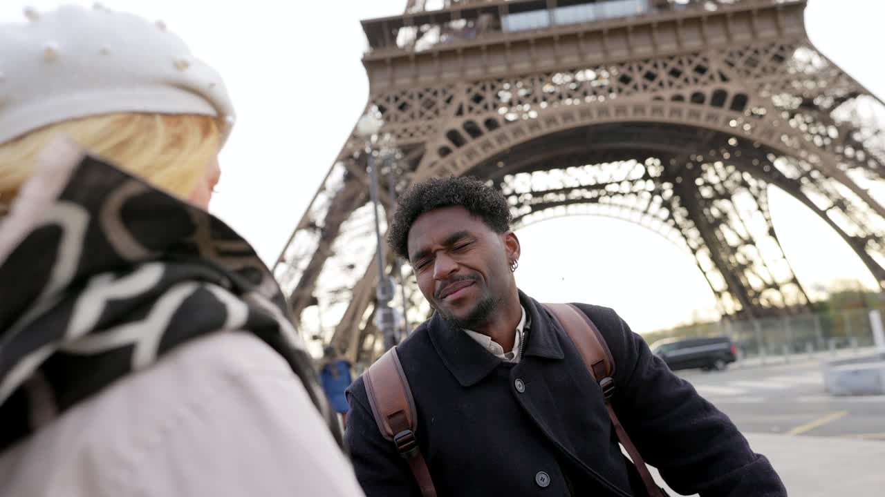 Couple sightseeing at the Eiffel Tower in Paris