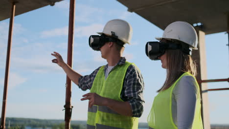 two contemporary crew workers using vr to visualize projects standing in unfinished building on construction site copy space