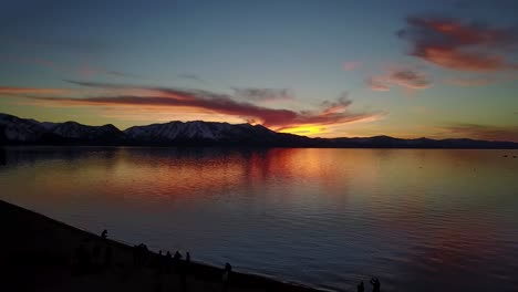 Aerial-of-sunset-over-Lake-Tahoe,-boats,-Lake