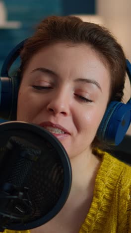 Vertical video: Close up of influencer talking on podcast microphone