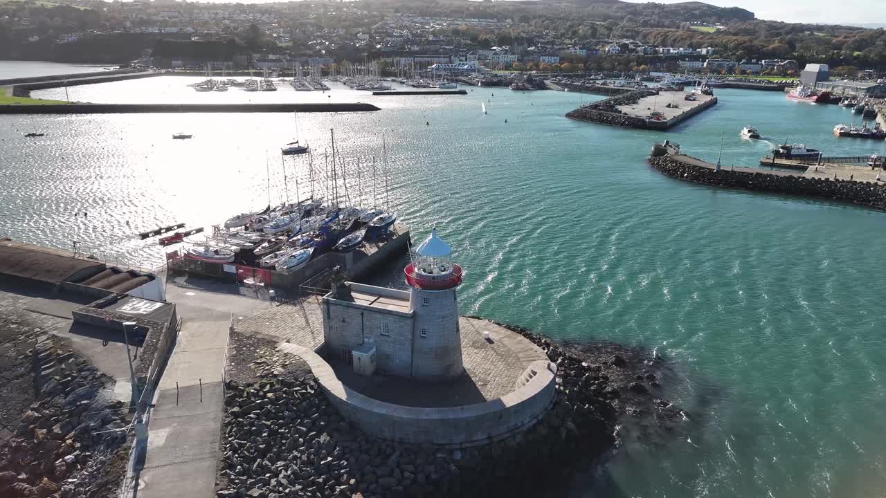 Drone reveal Howth village from lighthouse, coastal scenery. Dublin, Ireland. Sunny day