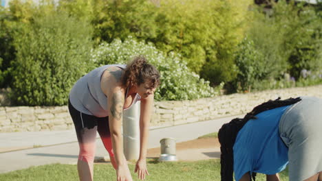 body positive women warming up with couch in park