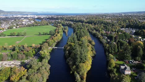 aerial-drone-footage-of-small-islands-on-Ness-river-in-Inverness,-Scotland-in-the-Highlands