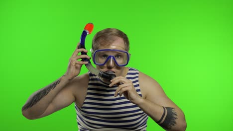 Emotional-man-tourist-in-underwater-mask-waving-hands,-striped-sailor-shirt