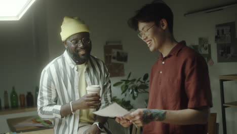 two men collaborating and discussing ideas in a creative workspace