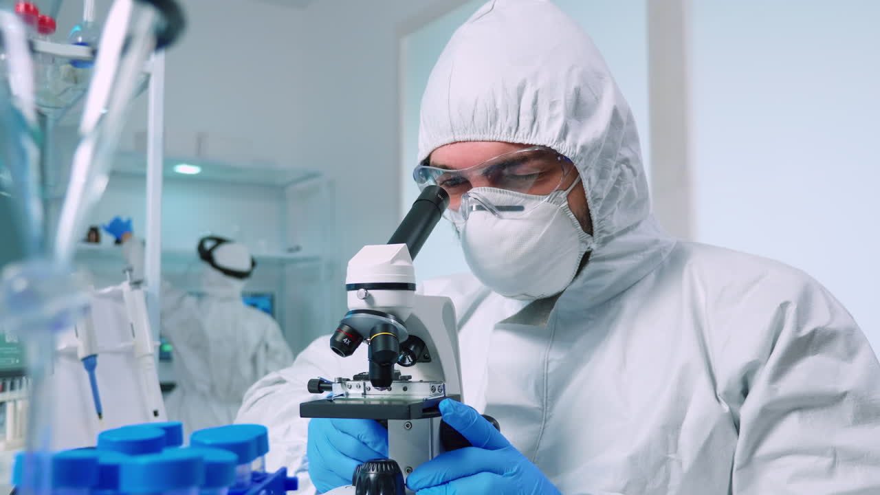 Biotechnology scientist in ppe suit researching DNA