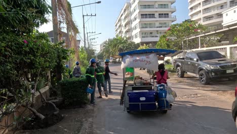 workers cleaning roadside with vehicle support