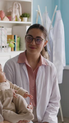 baby with mother visiting pediatrician