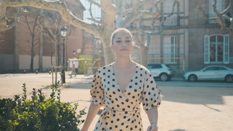 stylish young woman walking through the park.