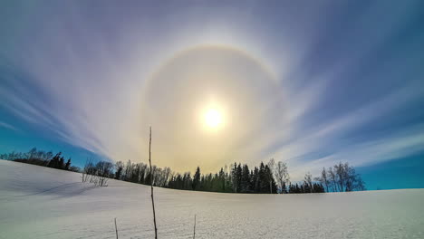 timelapse shot of beautiful sun halo during afternoon time over white snow covered field