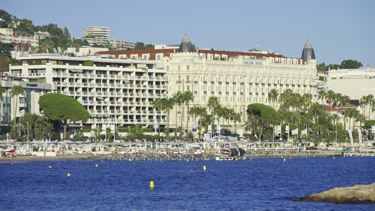 Cannes, France - June 22, 2025: Distant view of the Carlton Hotel on the coast of the Mediterranean sea