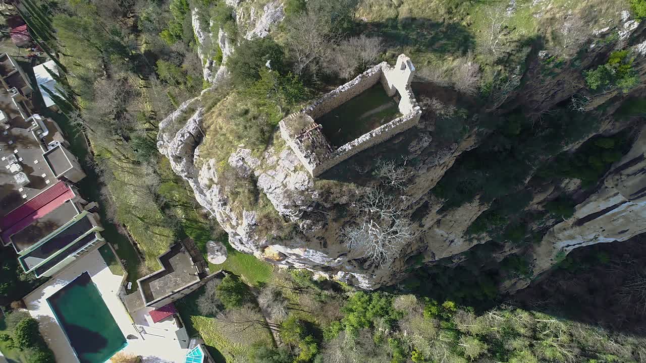 Aerial flight above ancient ruins of Church edgeof cliff. Motovun, Croatia