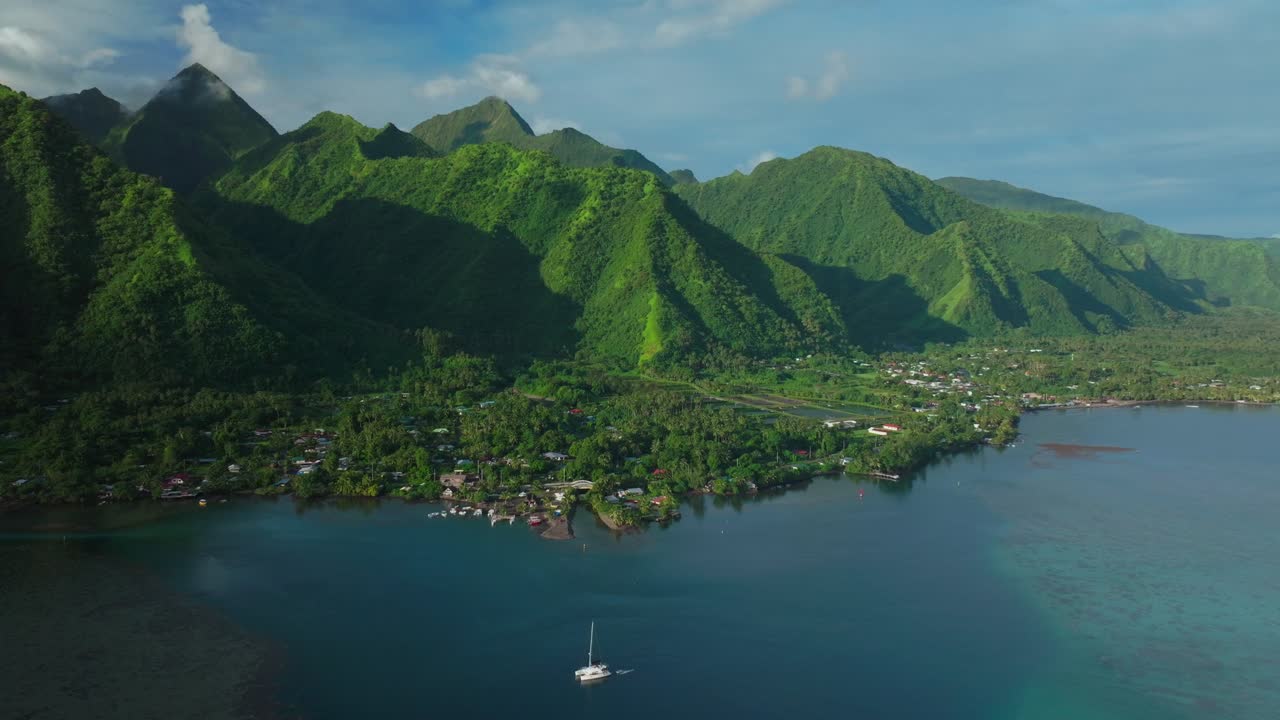 sailboat teahupoo tahití vista aérea de drones polinesia francesa verano de 2024 lugar de las olimpiadas de parís polinesia francesa océano pacífico arrecife de coral romper cimas verdes montañas tarde soleada islas círculo a la derecha
