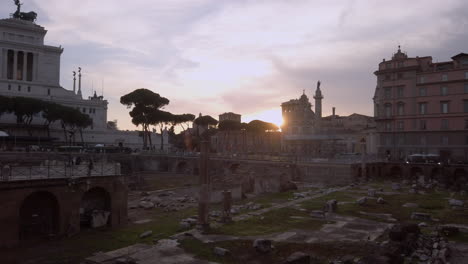 wide pan of roman forum ruins at sundown