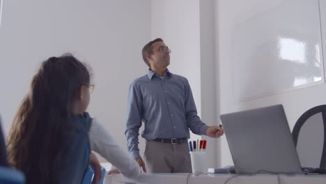 maestro de sexo masculino dibujando en pizarra