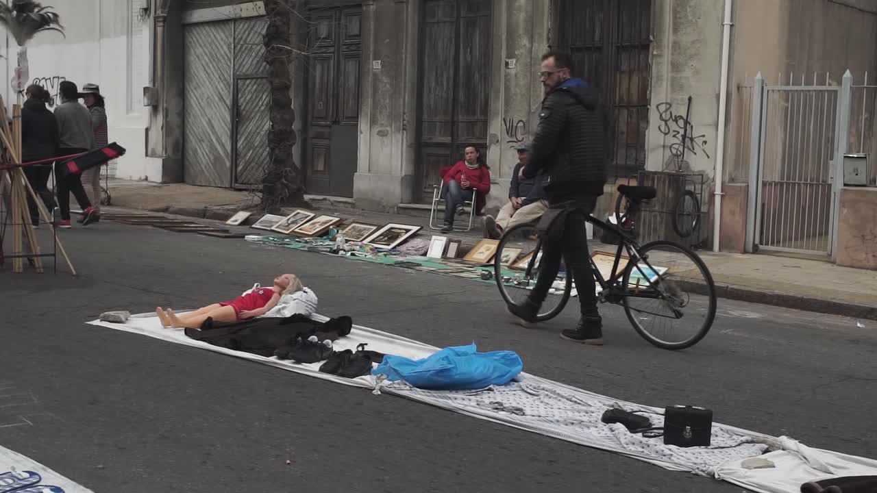 Static slomo shot of street vendors at Feria Tristan Narvaja, Montevideo