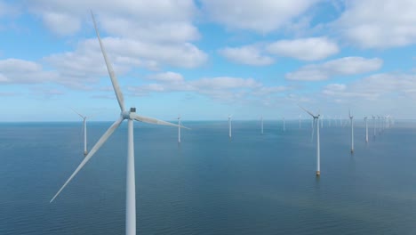 huge windmill turbines, offshore windmill farm in the ocean westermeerwind park , windmills isolated at sea on a beautiful bright day netherlands flevoland noordoostpolder