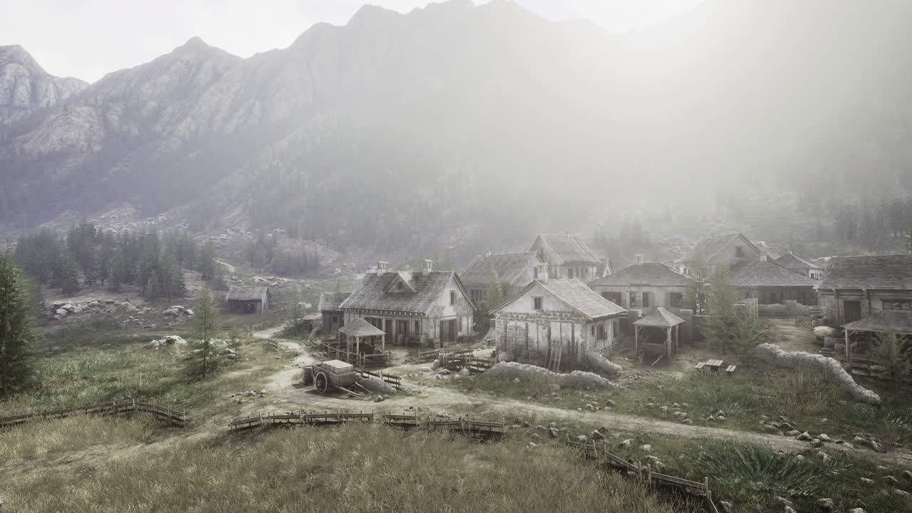 Quiet village surrounded by misty mountains in the early morning light