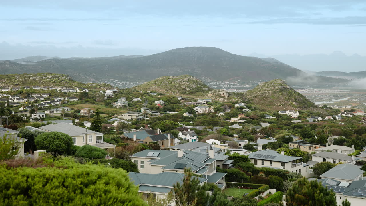 Cityscape with Houses and Mountain Backdrop