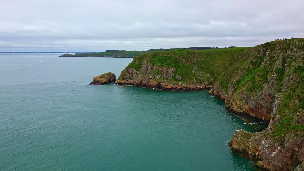 Aerial drone view of the dramatic green cliffs and turquoise sea along the beautiful coastline of Cap Fréhel, Brittany, France