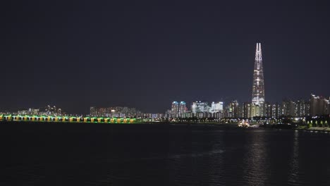 Night-scene-at-capital-city-Seoul-with-famous-landmark-Lotte-Tower-at-Han-River