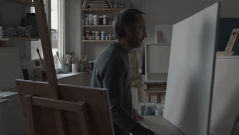 artist in studio painting