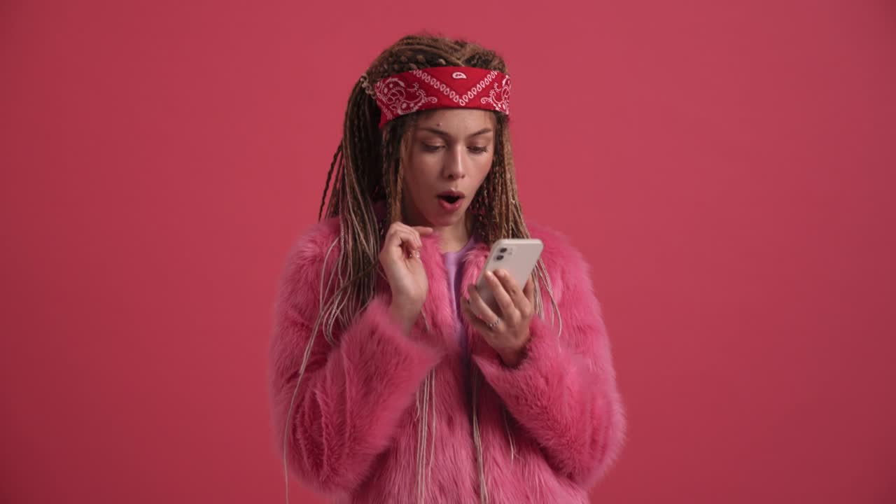 Pretty hippie woman typing by mobile