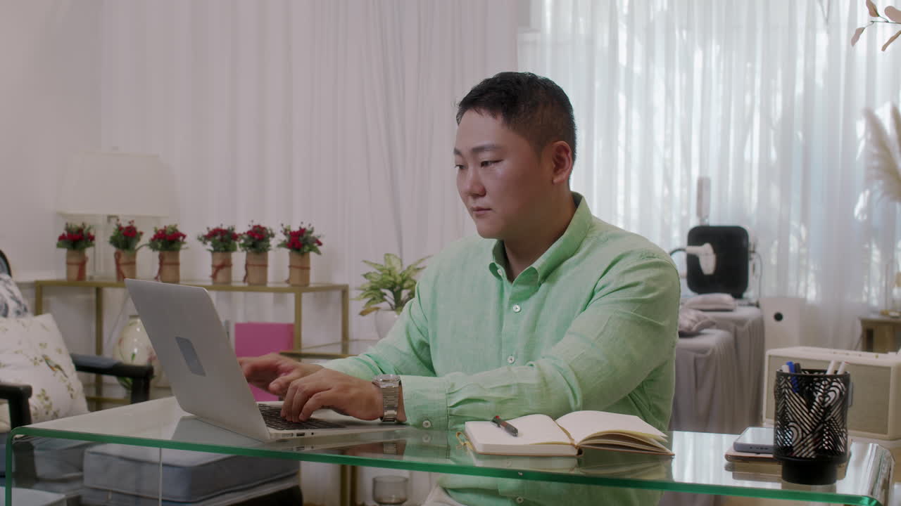 Asian Businessman Using Laptop in Own Spa Salon
