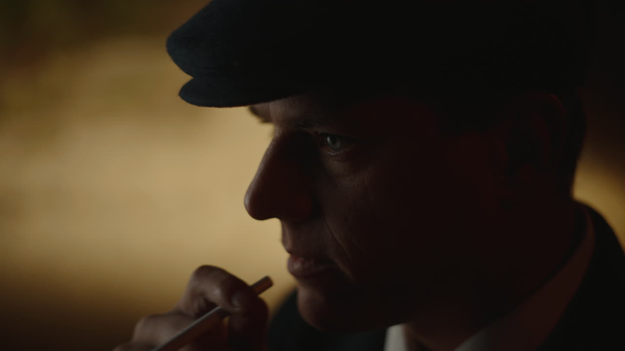 Man smoking cigarette in dark setting