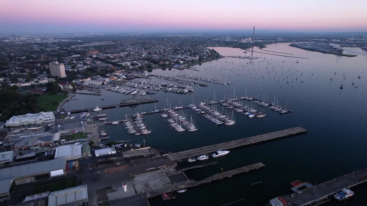 Aerial forward over harbour of Williamstown on blue hour, violet sunset sky