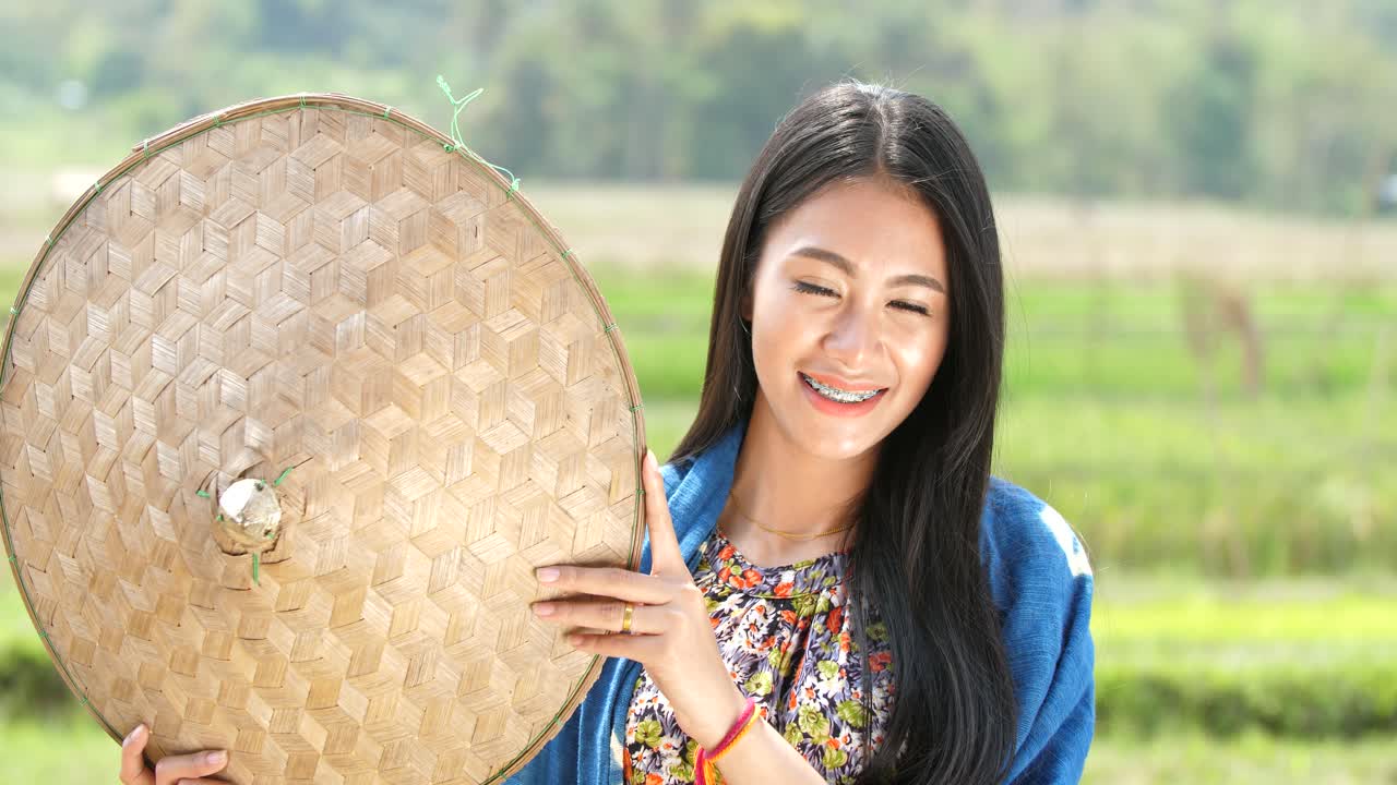Woman in a Rice Paddy with a Bamboo Hat