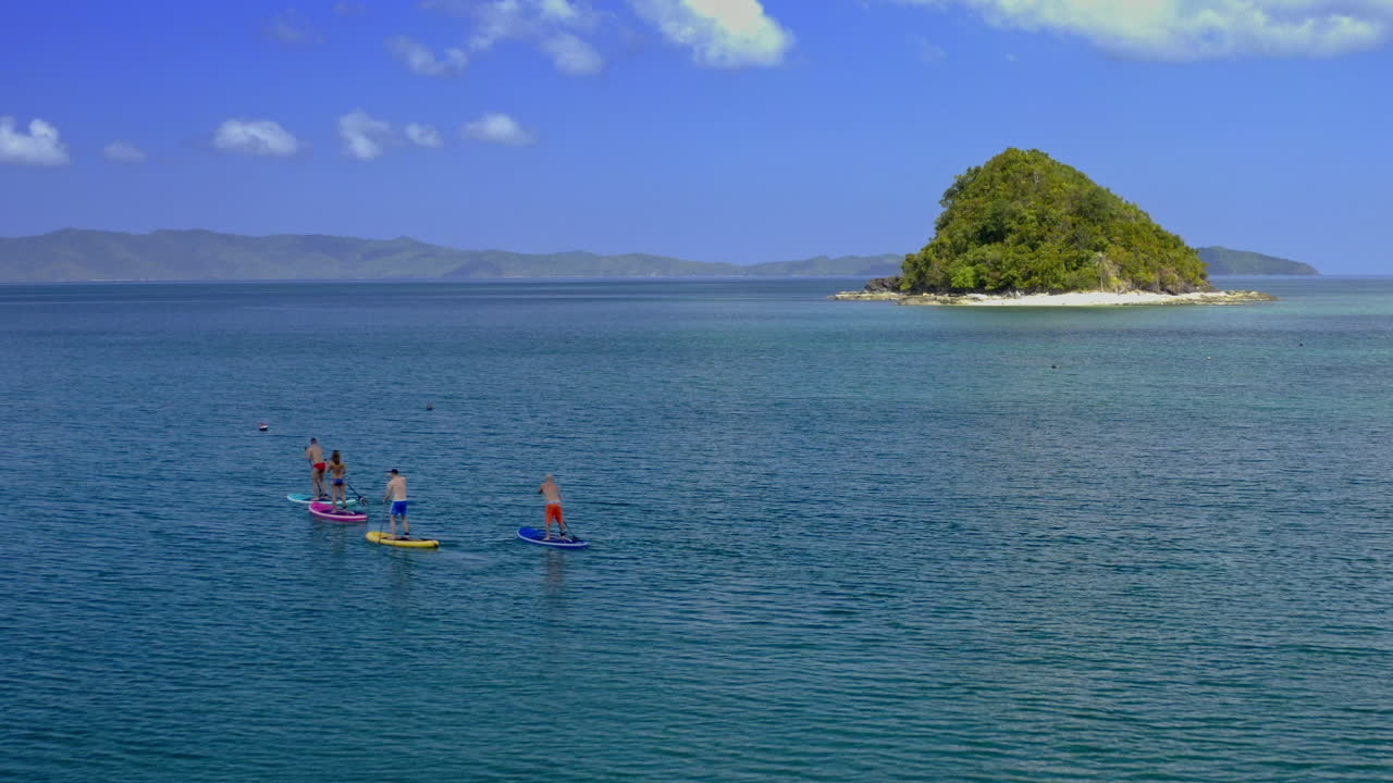 Paddleboarding near a tropical island
