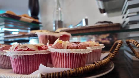 pink cupcakes with almonds on display