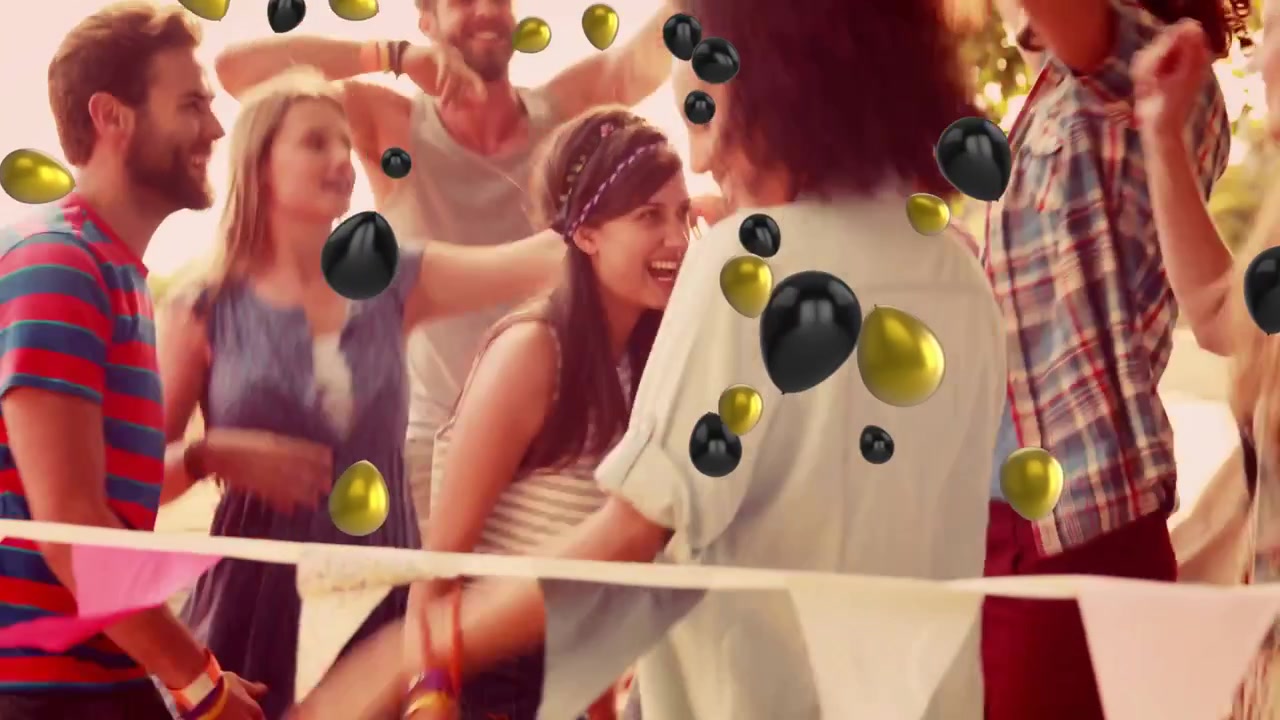 Danser til fest, folk omgivet af sorte og guld balloner, der svæver.