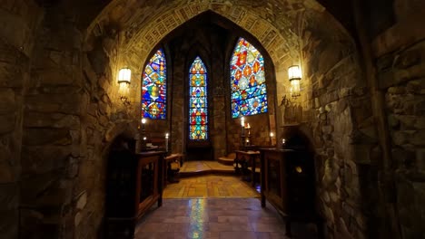 stained glass windows in a stone chapel