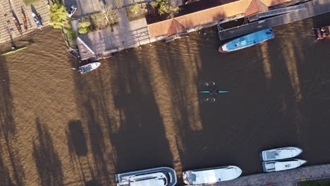 Rowing-Boat-Athletes-Training-On-Tigre-City-River-At-Sunset,-Aerial