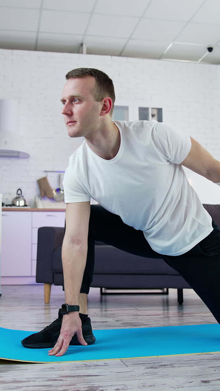 Young fit man in sportswear working out at home. Healthy lifestyle man doing yoga on quarantine