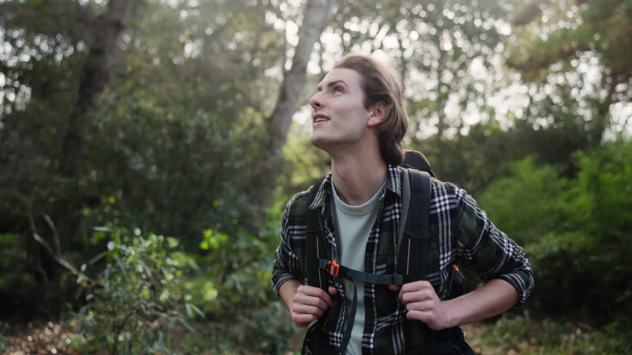 Man hiking in a forest with a backpack
