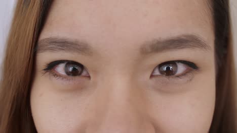 Close up of Middle Eastern young Woman Face, The girl has beautiful brown eyes, she smiles, frowns, draws her eyebrows