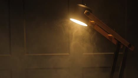 decorative lamp glowing indoors against the background of the wall. diffuse smoke and warm light from a light bulb