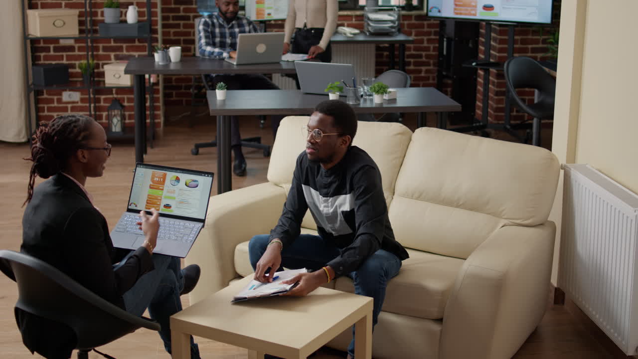 Team of colleagues using marketing statistics to plan financial growth