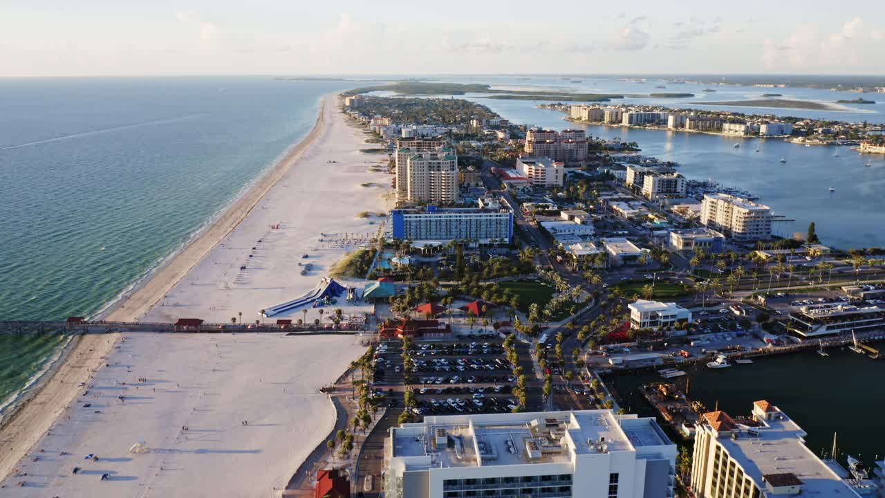 Clearwater Beach stretches in a long ribbon of white sand along the Gulf of Mexico, with a pier, high-rise resorts, and winding inland waterways completing the coastal view