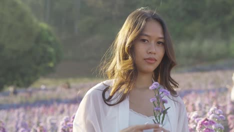 happy thai woman having fun in a flower field