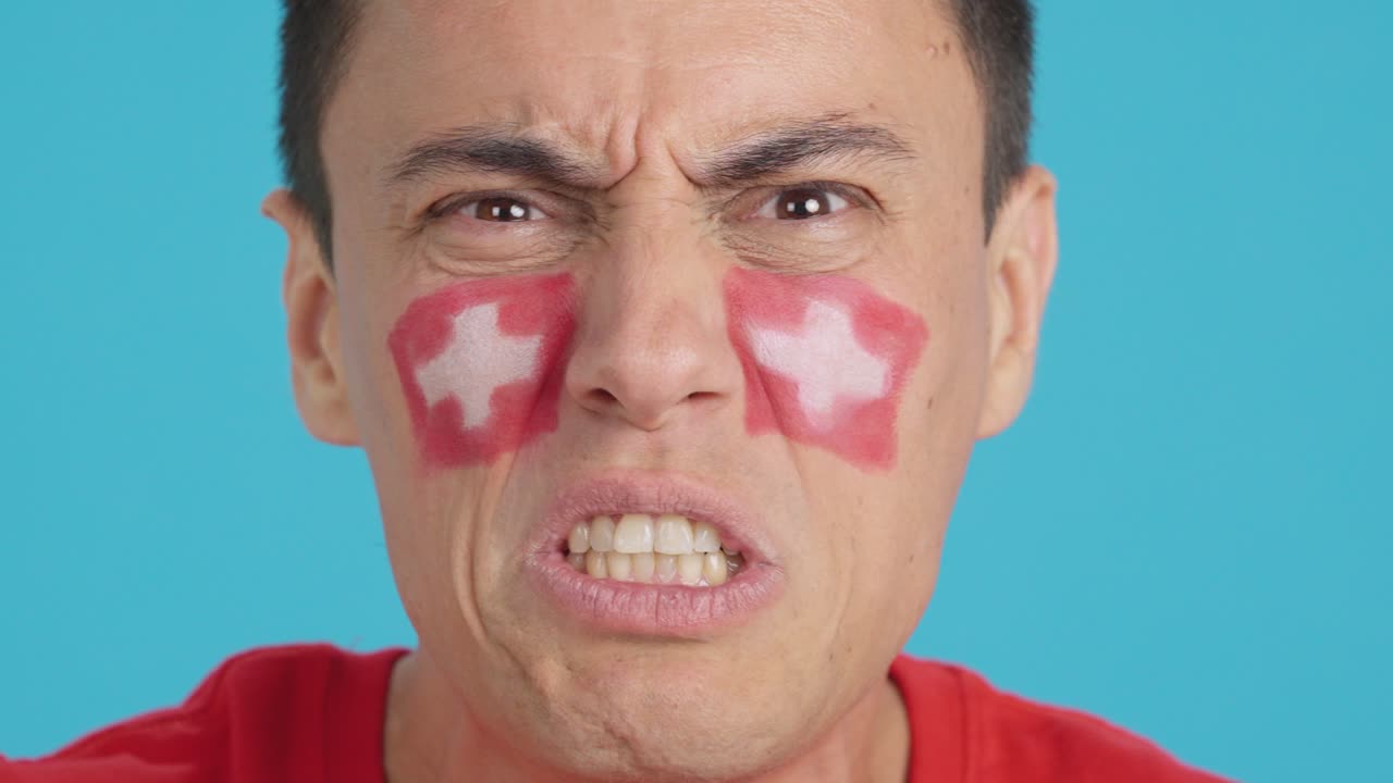 Man with swiss national flag upset with a referee