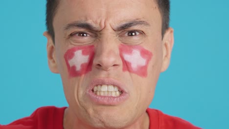 man with swiss national flag upset with a referee