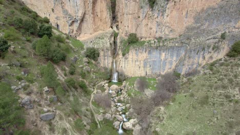 waterfall flowing down the ravine and forming a great torrent of water