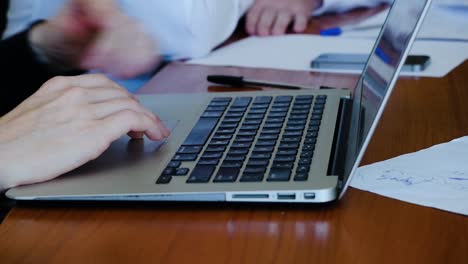 people working on laptops in a meeting