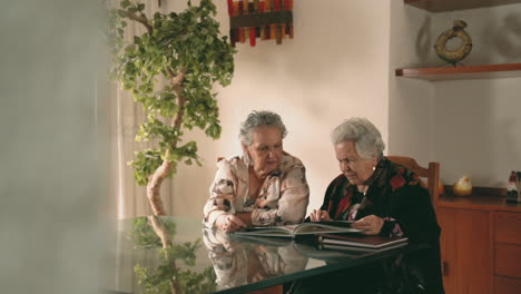 aged women examining photos together